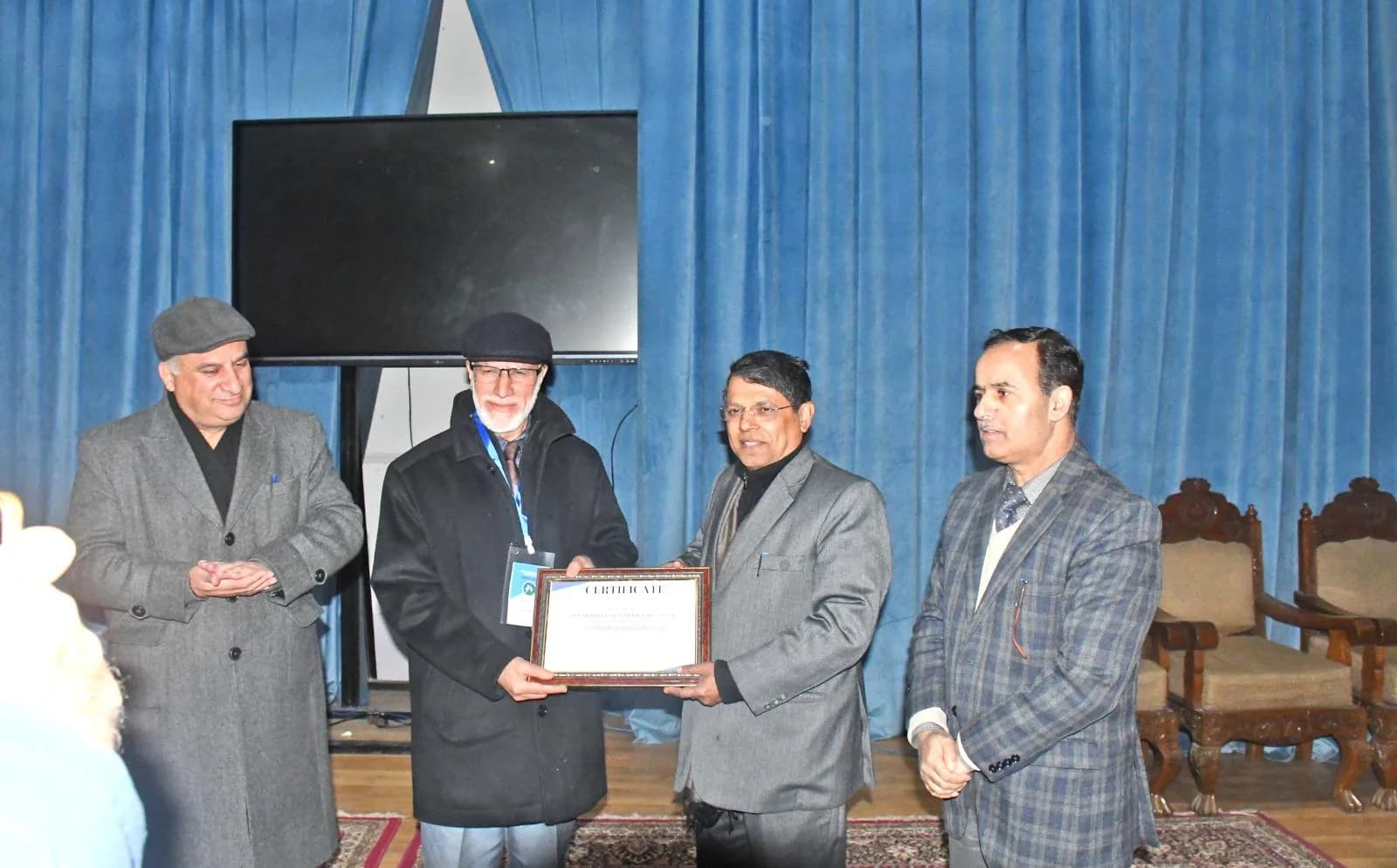 Dr. Mushtaq Ahmad Margoob receiving a certificate at an academic gathering